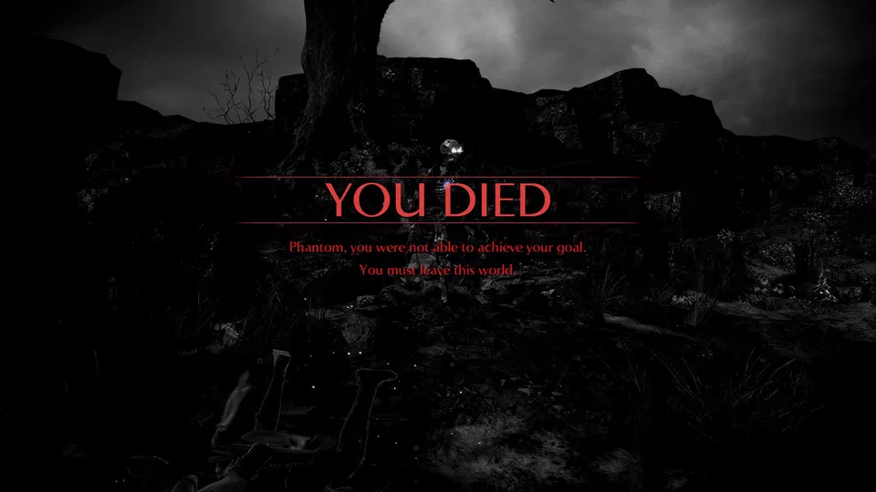 Demon's Souls: obrazovka smrti s červeným nápisem YOU DIED nad tmavou krajinou s hlavami postav